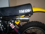 New 1976 Suzuki RM125A Repackable Aluminum Silencer Kit 14310-41300. Fixed Price $149.95.